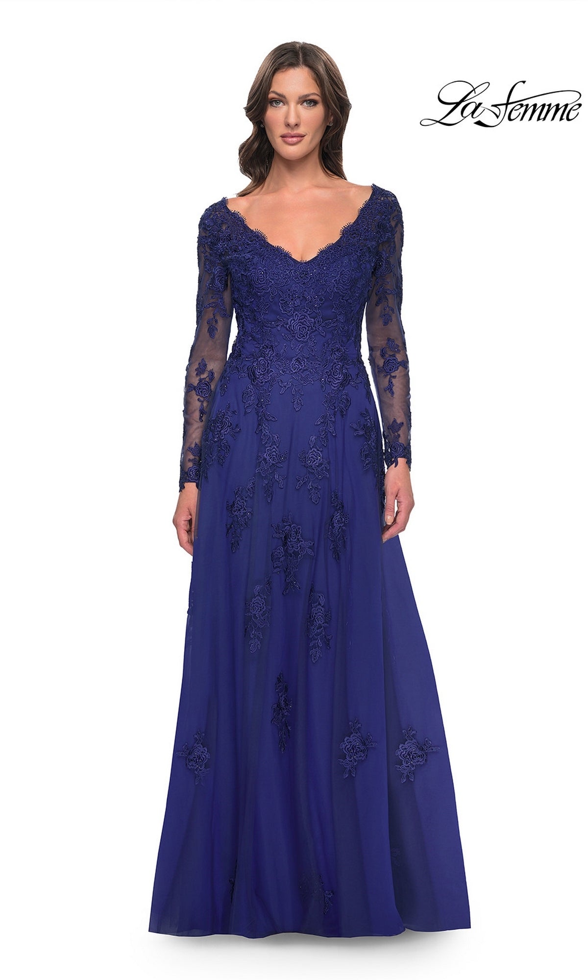 A woman wears a marine blue Long Formal Dress: La Femme 30795, a gown featuring beaded lace appliqués on the V-neck bodice and a tulle A-line skirt.